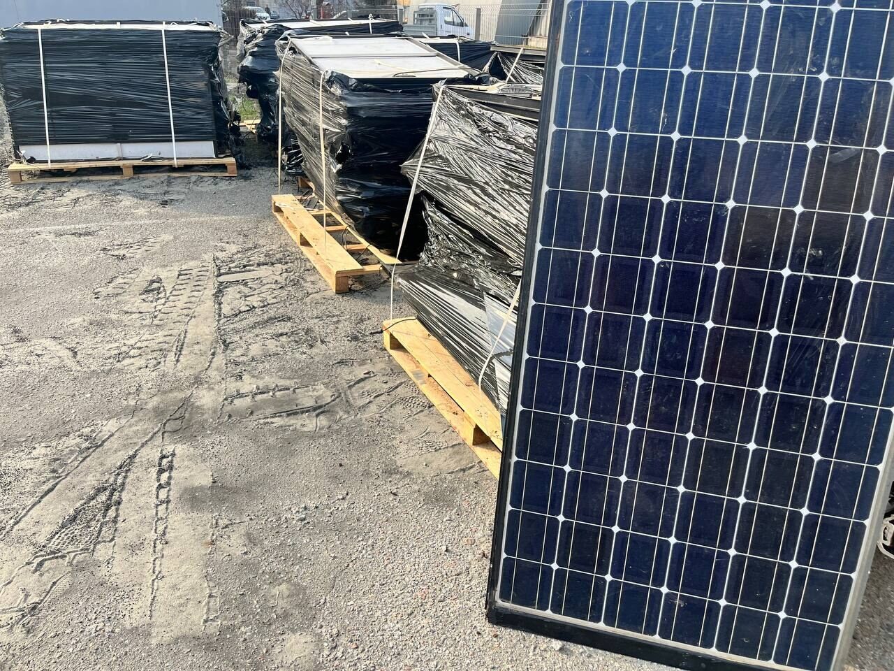 Used solar panels on pallets in a yard